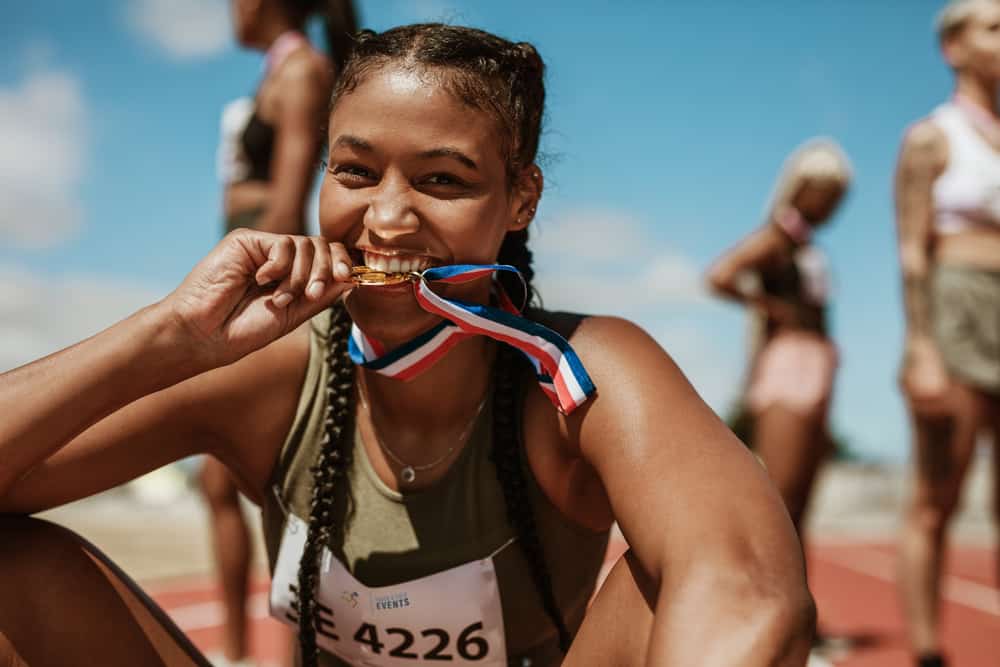 An athlete celebrating a win, showcasing the benefits of chiropractic care for athletes.